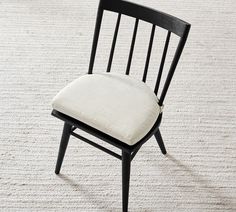 a black chair with a white cushion on it