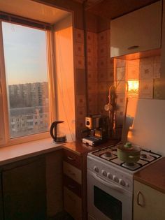 a kitchen with a stove top oven next to a window