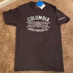 Columbia Shirt Small New With Tags Heathered Dark Gray With White Columbia Sportswear Co. And Rope Decal On Front. White Columbia On Left Sleeve 50% Cotton / 50% Polyester Smoke Free, Pet Free Home Casual Tops For Outdoor Sports Season, Casual Tops For Outdoor Sports, Sporty Tops With Logo Print For Outdoor, Casual Logo Print Tops For Outdoor, Casual Tops With Logo Print For Outdoor, Casual Outdoor Tops With Logo Print, Casual Sports Shirt For Spring, Graphic Print Tops For Outdoor Sports Activities, Casual Gray Sports Shirt