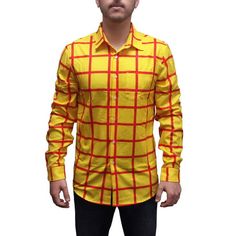 a man wearing a yellow shirt with red squares on the front and chest, standing in front of a white background