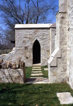 an old stone building with a door and steps leading to the entrance into the yard