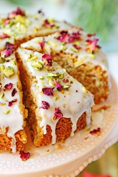 a cake with white frosting and sprinkles sitting on top of a plate