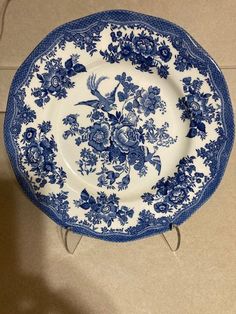 a blue and white plate sitting on top of a counter next to a knife holder