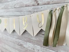 a banner that says baby hanging on a wall with ribbons attached to the back of it