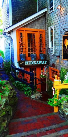 the entrance to hideaway is painted bright orange and has steps leading up to it