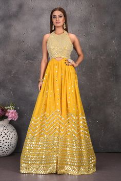 Buy stunning yellow halter neck mirror work jumpsuit online in USA. Look stylish at parties and wedding festivities in designer dresses, Indowestern outfits, Anarkali suits, wedding lehengas, palazzo suits, sharara suits from Pure Elegance Indian clothing store in USA.-full view Yellow Georgette Dresses With Gota Work, Floor-length Yellow Dress For Festivals, Embellished Maxi Dress For Party And Festivals, Gold Gown With Mirror Work For Party, Yellow Georgette Dress With Mirror Work, Bollywood Style Yellow Reception Dress, Gold Party Gown With Mirror Work, Festive Evening Dresses With Gota Work, Yellow Sleeveless Wedding Gown