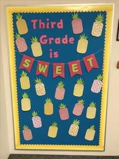 a classroom door decorated with pineapples and banner that says third grade is sweet