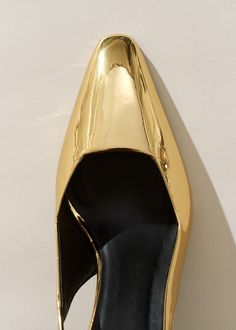 Elegant Patent Leather Mules For Parties, Modern Metallic Pointed Toe Heels, Modern Gold Patent Leather Heels, Modern Metallic Mules For Formal Occasions, Modern Metallic Mules For Evening, Chic Metallic Slingback Pumps For Formal Occasions, Gold High Heel Mules With Sculpted Heel, Chic Metallic Mules With Sculpted Heel, Sleek Metallic Patent Leather Heels