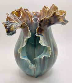 a vase that has been made to look like an open flower bud in blue and brown