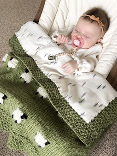 a baby laying in a crib with its mouth open