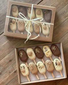 a box filled with chocolate covered desserts on top of a wooden table