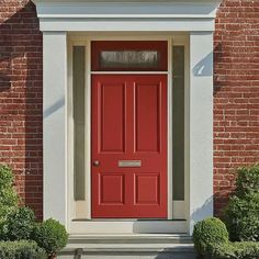 a red front door on a brick building