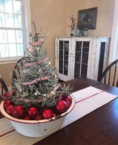 a small christmas tree in a bowl on a table