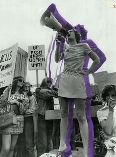 a black and white photo of a woman holding a megaphone in front of a crowd