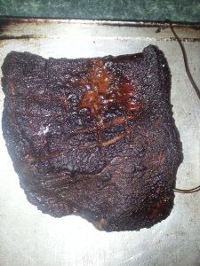 a square piece of meat sitting on top of a pan