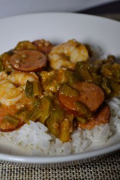 a white plate topped with rice and shrimp