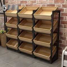 the wooden shelves are stacked on top of each other in front of a brick wall