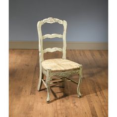 a white chair sitting on top of a hard wood floor next to a wooden floor