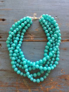 "Bright turquoise beaded necklace featuring 5 strands of lightweight lucite beads. This 5 strand statement necklace style is known as the Sylvie Necklace. Beads are shiny translucent and marbled finish in that great retro look & they were made in the 1960's. Necklace measures 15.5-16\" at it's shortest + a 6\" extender. Lightweight and fun to wear: a classic style that will outlast trends. Most all jewelry is hand finished & designed here in the US. Jewelry parts are salvaged as leftover Turquoise Beaded Necklace, Shine Jewelry, Everyday Earrings Studs, Padlock Necklace, Beads Craft Jewelry, Wedding Necklaces, Bright Turquoise, Chandler Az, Necklace Beads