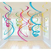 multicolored streamers hanging from the ceiling in an empty room with white walls