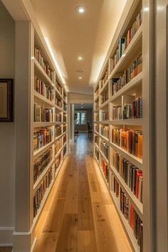 a long narrow hallway with many books on the shelves