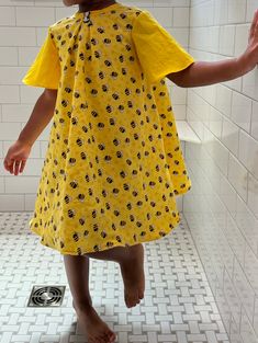 Get at least 2 years out of this dress! A wide back with buttons allows for incredible breathability and extended sizes. Super cool back to school dress, those dress is made to last with double seams and generous sizing. It's lined with 100% cotton and all cotton bumble bee print yellow fabric. Beautifully hand crafted in Richmond, VA.  We live in a very hot and very humid environment so I always try to make kids clothes that won't cling to the skin and allow a breeze to pass through.  Meterials Yellow Cotton Sundress With Short Sleeves, Yellow Cotton Dress With Relaxed Fit, Playful Multicolor Cotton Dress, Yellow Cotton Dress Relaxed Fit, Yellow Relaxed Fit Cotton Dress, Yellow Bee Dress, Bumble Bee Dress, Playful Rainbow Cotton Dresses, Bee Kids Dress