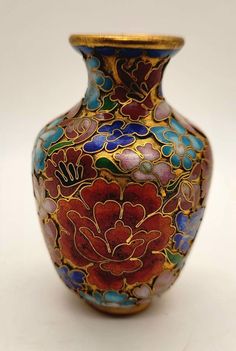 a colorful vase with flowers painted on it