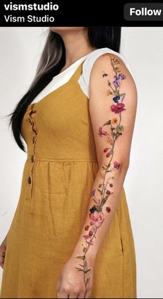 a woman's arm with flowers on it and the words, vismstudio