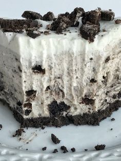 a piece of ice cream cake with oreo cookies on the top and frosting