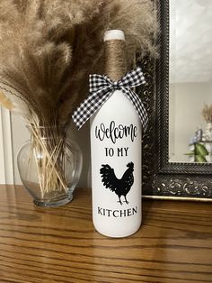 a welcome to my kitchen bottle with a rooster on it