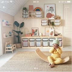 a baby sitting on the floor in a playroom with toys and bookshelves