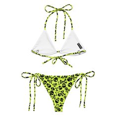 Make a haunting splash with Goth Cloth Co.'s Lime Bones String Bikini. Featuring a daring pattern of skull and crossbones on a lime green background, this set blends gothic elegance and punk rock flair, perfect for all your beach and poolside adventures. Key Features: Recycled polyester fabric: Soft and stretchy material with UPF 50+, made from recycled polyester. Removable padding: Bikini top includes removable padding for customizable comfort. Double-layered construction: Ensuring comfort and Green Rave Swimwear, Festival Green Printed Swimwear, Green Fitted Swimwear For Festivals, Rave Swimwear For Summer Costume Party, Fitted Halloween Swimwear For Pool, Lime Green Background, Gothic Elegance, Punk Skull, Recycled Polyester Fabric