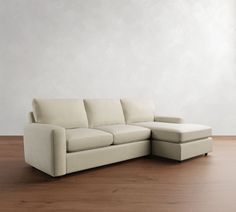 a white couch sitting on top of a wooden floor