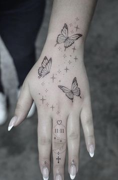 a woman's hand with three butterflies on it and the word love written in black ink