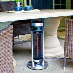 an outdoor table with a heater on it