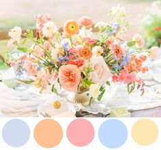 a vase filled with flowers sitting on top of a table next to plates and utensils