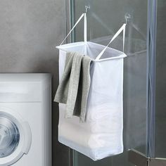 a laundry bag hanging from the wall next to a washing machine