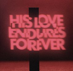 a cross with the words his love endurors forever projected on it