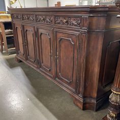 a large wooden cabinet sitting on top of a floor