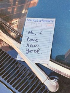 a note attached to the hood of a car