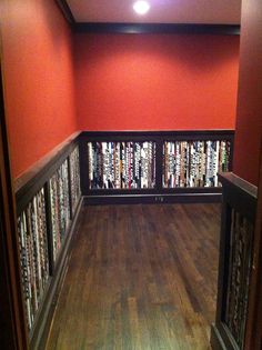 an empty room with bookshelves in the middle and wood floors on both sides