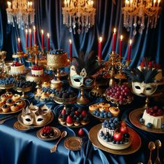 a table topped with cakes and desserts covered in masquerade masks