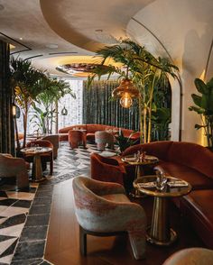 the interior of a fancy restaurant with potted plants