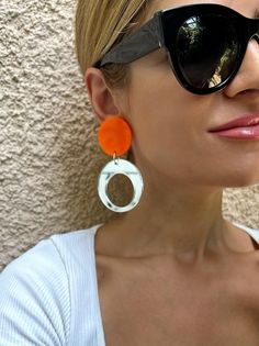 A Pair of Hoop Earrings that are made from Plexiglass and they open and close with Clip On. I used summer colors and the upper part is in orange color and the down hoop is made in a unique silver mirror color that smells summerThis pair is ideal for non pierced ears, they are comfortable and light.  Find them only at Chrstina Christi Store. MATERIALS - Plexiglass Parts. - Metal Parts. DIMENSIONS - Total length of Earrings: 9 cm (3.5') - Total width of Earrings: 3.5 cm (1.35') PROTECTION - Protec Modern Clear Drop Earrings, Modern White Clip-on Earrings, Modern Clear Dangle Earrings, Trendy White Small Hoop Earrings, Trendy White Round Hoop Earrings, Modern Handmade Clip-on Earrings, Trendy Clear Drop Earrings, Modern Clear Round Earrings, Modern Orange Drop Earrings