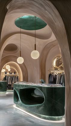 the interior of a clothing store with green marble counter tops and circular lights hanging from the ceiling