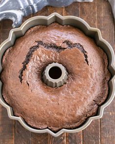 a chocolate bundt cake sitting on top of a wooden table