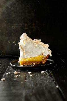 a piece of pie sitting on top of a black plate