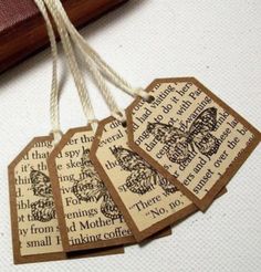 four tags with words on them hanging from string