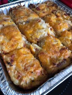 a pan filled with cheesy bread on top of a table