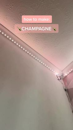 a bathroom with pink walls and lights on the ceiling is pictured in this ad for champagne